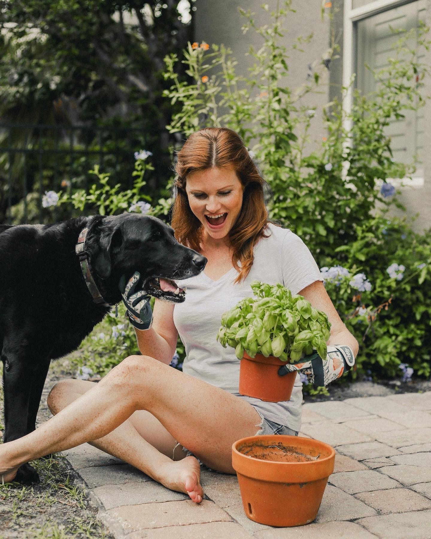 Lydia, her dog, and a basil plant